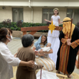 Sister-Jaye-Segura,-holding-her-own-baby,-poses-as-Mary-as-Japanese-guests-watch.-(2).jpg